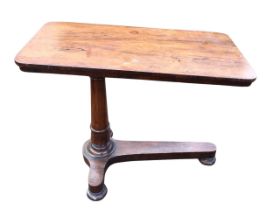 A William IV mahogany reading table, the rounded rectangular top raised on a turned column with T-