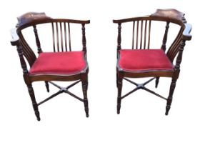 A pair of Edwardian mahogany corner chairs, the shaped crestrails inlaid with floral panels, on