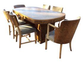 An art deco walnut dining room suite with rounded table on rectangular chamfered column supports