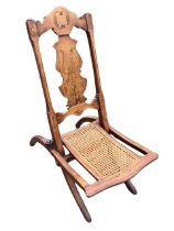 A Victorian walnut and folding chair, the shaped back splat and columns inlaid with foliate and