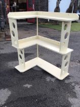 A 60s painted L-shaped corner shelf, the open platforms with raised backs, the sides pierced with
