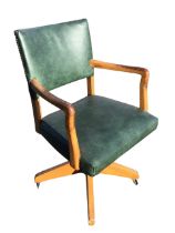 A 50s revolving beech desk chair with rectangular faux leather upholstered back and seat flanked