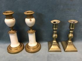 A pair of regency Empire style gilt brass and ceramic candlesticks, the candleholders shaped tops
