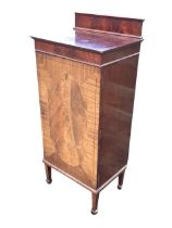 An Edwardian chequer strung mahogany music cabinet, the raised back with moulded cornice above an