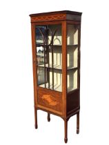 An Edwardian boxwood strung mahogany display cabinet, the moulded cornice above frieze inlaid with
