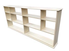 A painted hardwood open bookcase, the chamfered rectangular top above ten compartments, on a