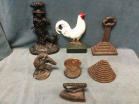 A collection of six Victorian and later cast iron doorstops - a woodsman & dog, a market cross, a