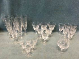 A suite of cut glass dinking glasses with tapering bowls on squat columns and circular bases - wine,