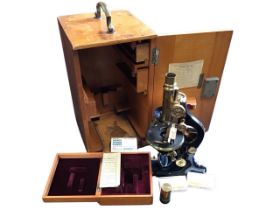 A mahogany cased Leitz japanned and lacquered Brad medical microscope with mechanical table,