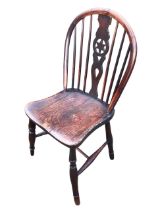 A Georgian elm wheelback chair with hooped back with pierced splat flanked by spindles, above a