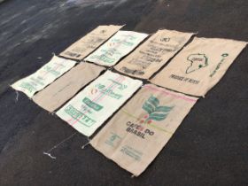 Eight jute coffee bean sacks, stencilled with trademarks and countries of origin - Brazil, Colombia,