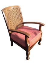A 20s hardwood armchair, the caned back above a rectangular seat with loose cushion, flanked by