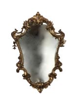An Italian style rococo scrolled mirror, the plate surmounted by an acanthus crest with tapering