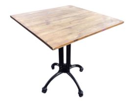 A square pine and enamelled steel table, raised on an industrial style tubular column with