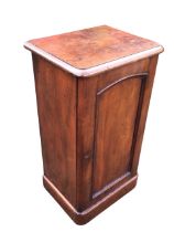 A Victorian mahogany pot cupboard, the moulded top above an arched panelled door, raised on