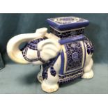 A Chinese stoneware garden seat modelled as an elephant with blue glazed decoration to howdah on