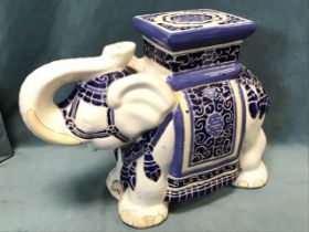 A Chinese stoneware garden seat modelled as an elephant with blue glazed decoration to howdah on