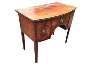 A small regency bowfronted mahogany sideboard, the boxwood and ebony strung top above a central