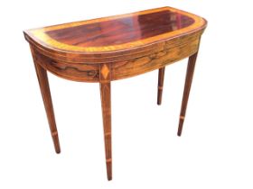 A Georgian rosewood fold-over top card table, the curved satinwood banded top opening on swing