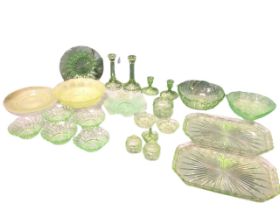A collection of green uranium glass including fruitbowls, two dressing table sets on trays with
