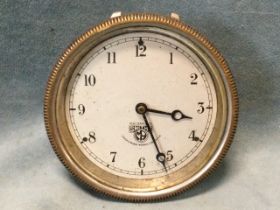 A Smiths vehicle clock, the silvered dial with arabic numerals under bevelled glass with ribbed