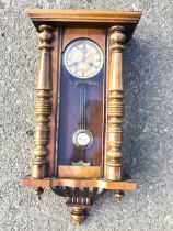 A C19th Vienna wall clock, the rectangular cornice above an arched glazed door flanked by turned