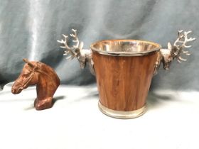 A tapering ice bucket with silver plated stag head mounts, having steel liner; and a patinated