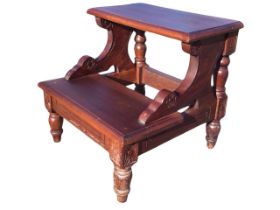 A set of mahogany bed steps, the moulded rectangular treads on shaped carved brackets and turned