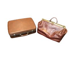 A Texier leather gladstone style French travel bag, with brass mounted closure, lock and leather