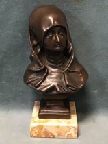 A bronze bust of a lady, wearing medieval Flemish costume, unsigned, on a square socle and marble