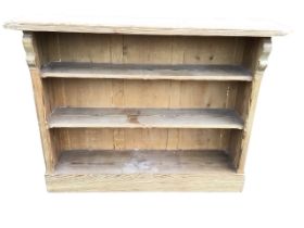 A Victorian pine open bookcase, the moulded rectangular top above three chamfered shelves, flanked