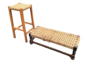 An oak long stool with woven seagrass seat raised on baluster legs, joined by stretchers - 32.