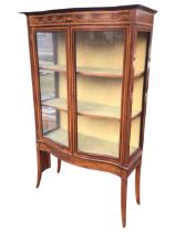 An Edwardian mahogany satinwood crossbanded bowfronted display cabinet, the moulded cornice above