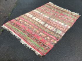 A Turkish wool kilim rug, the field with stripes of lozenges, chevrons, hooked diamonds, zigzags,