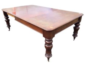 A Victorian mahogany extending dining table, the rectangular top with spare leaf, above a beaded