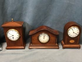 Three Edwardian mahogany mantleclocks having moulded cases with brass mounts inlaid with boxwood