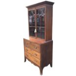 A regency mahogany secretaire bookcase, the moulded cornice above a pair of gothic astragal glazed