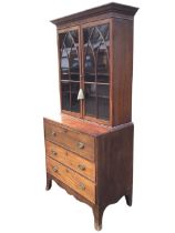 A regency mahogany secretaire bookcase, the moulded cornice above a pair of gothic astragal glazed