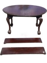A Victorian mahogany extending dining table with two leaves, the oval top with gadrooned edge raised