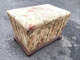 A Victorian upholstered sarcophagus shaped ottoman, the rectangular top opening to a fabric lined
