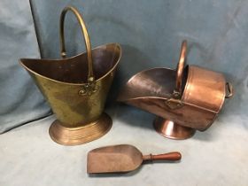 A Victorian oval brass double-lipped coal scuttle, with swing handle, the tapering body raised on