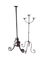 A heavy Edwardian wrought iron light stand with scrolled supports to column; and a three-branch