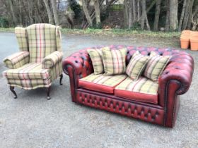 A leather two-seater chesterfield sofa with Georgian style wing armchair, both with matching tweed
