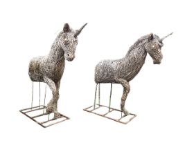 A pair of woven cane garden sculptures modelled as unicorns, on metal stands with rectangular bases.