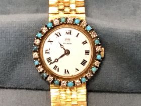 A 1950s Milner 9ct gold ladies cocktail watch, the enamelled dial with roman chapters framed by