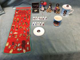 A golly collection including enamelled badges, figurines, thimbles, mugs, etc. (A lot)