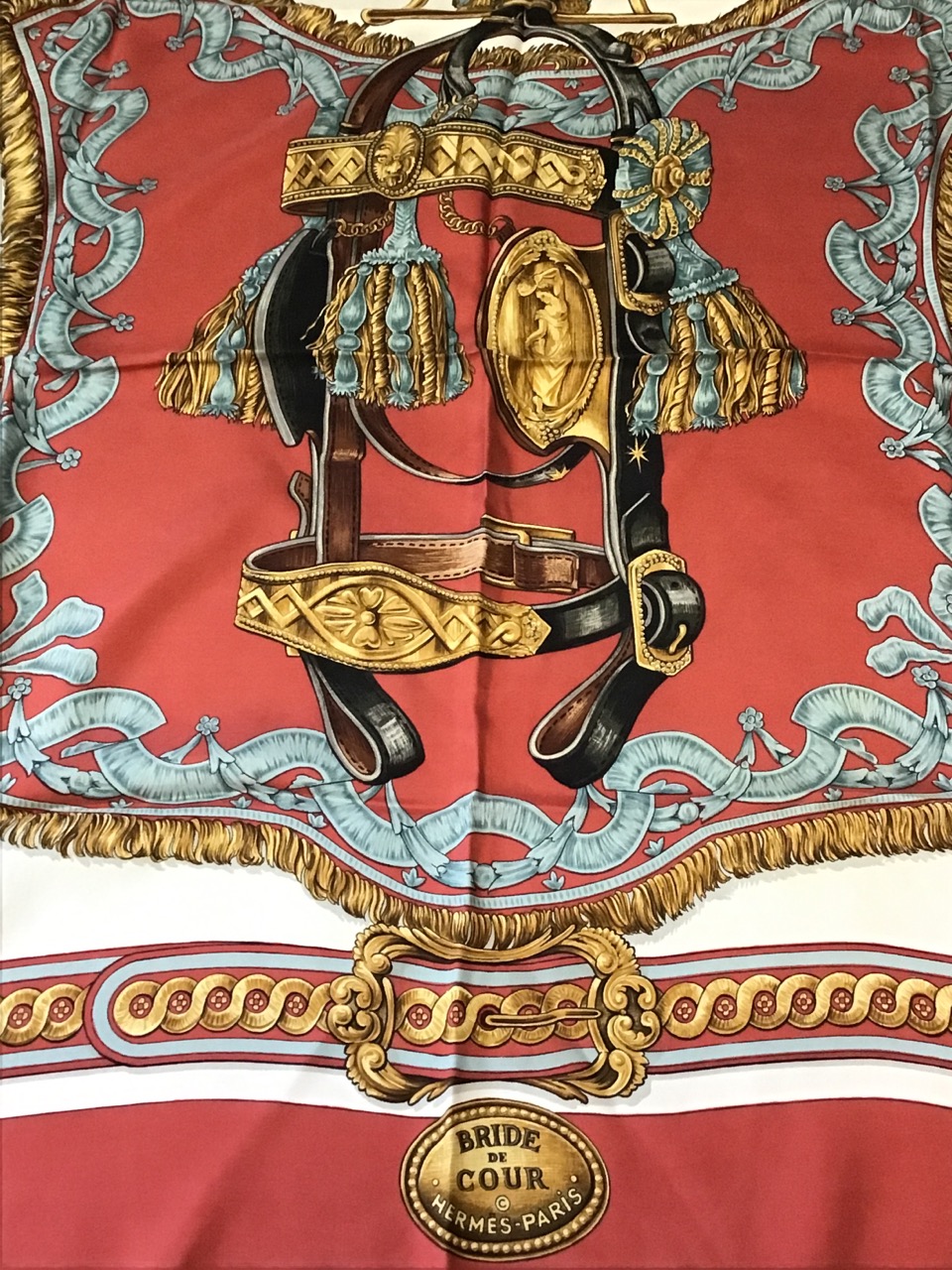 A Hermès Bride de Cour silk scarf, depicting a tasseled bridle on red ground, by F de La - Image 3 of 3