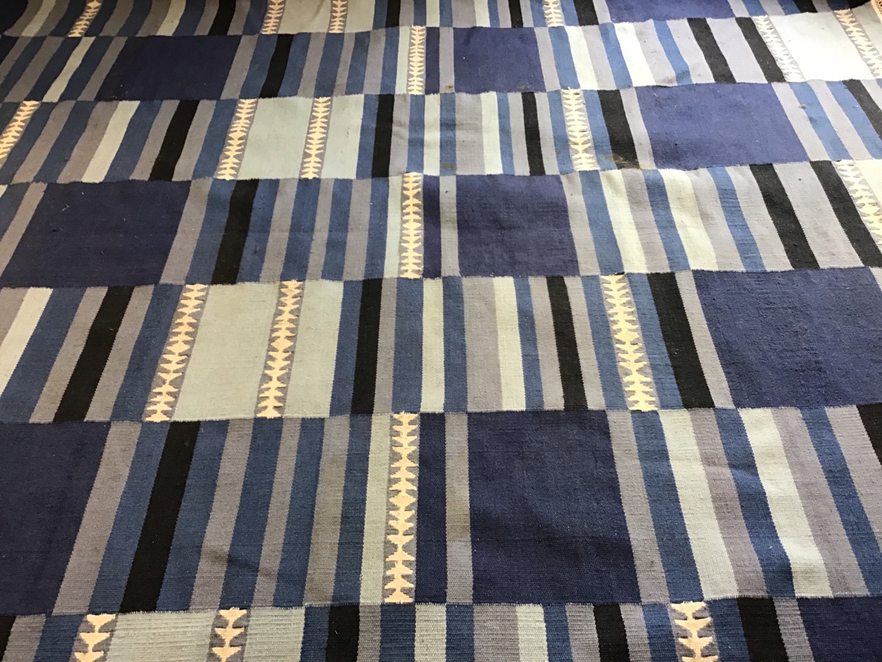 A contemporary wool kelim carpet woven with striped bands in shades of blue. (96in x 68in) - Image 2 of 3