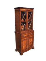 An Edwardian mahogany Georgian style secretaire bookcase with dentil cornice above a pair of