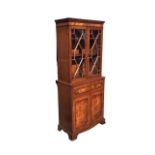 An Edwardian mahogany Georgian style secretaire bookcase with dentil cornice above a pair of